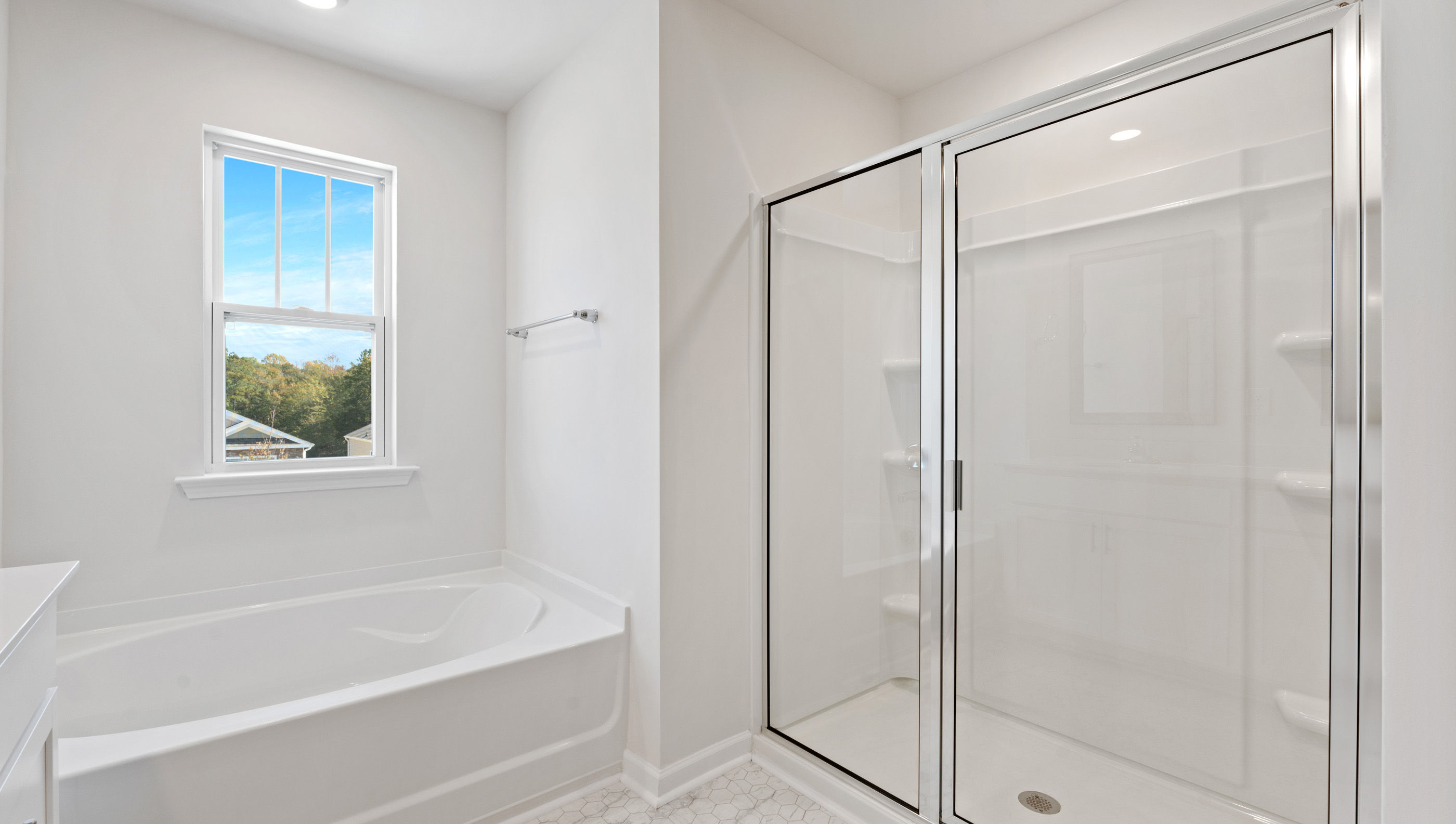 Primary bathroom walk-in shower and garden tub.