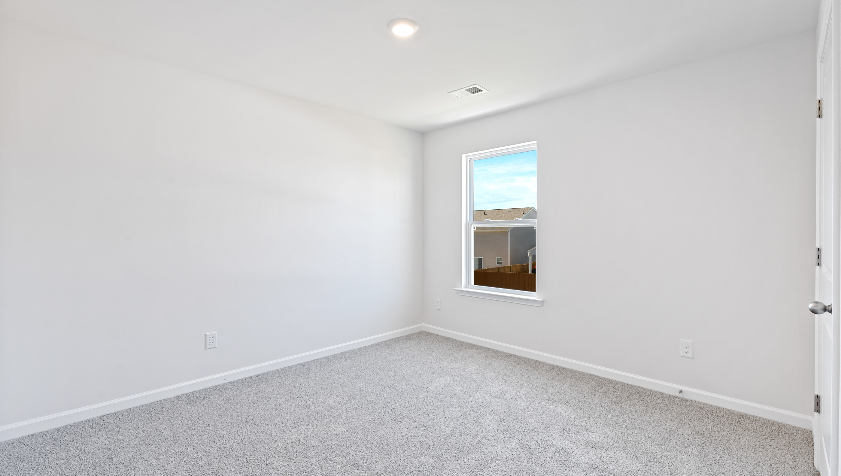 Bedroom with window and carpet.