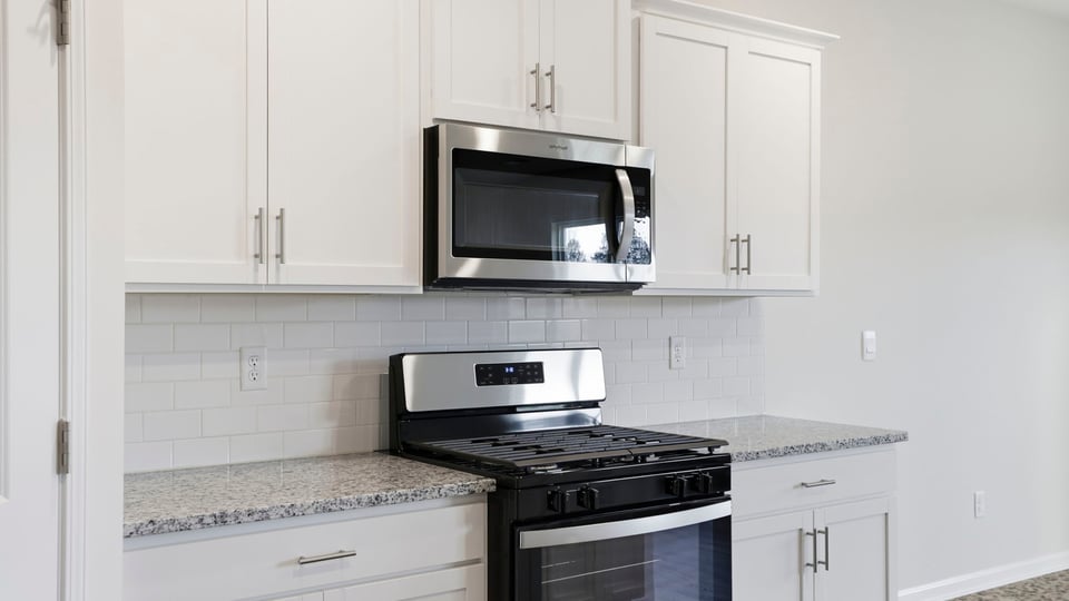 Kitchen features stainless steel appliances.