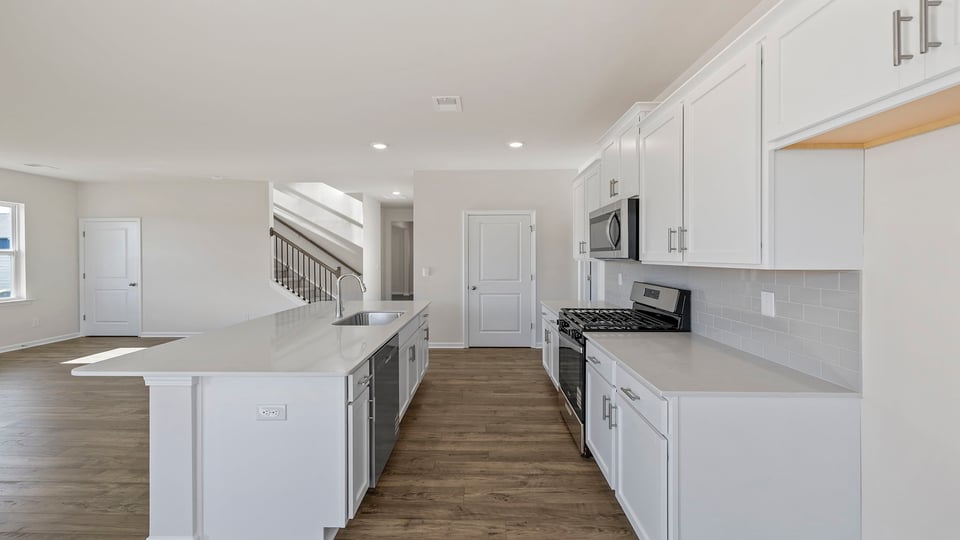 Quartz countertops and white cabinetry.