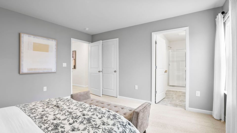 Bedroom with carpet and window.