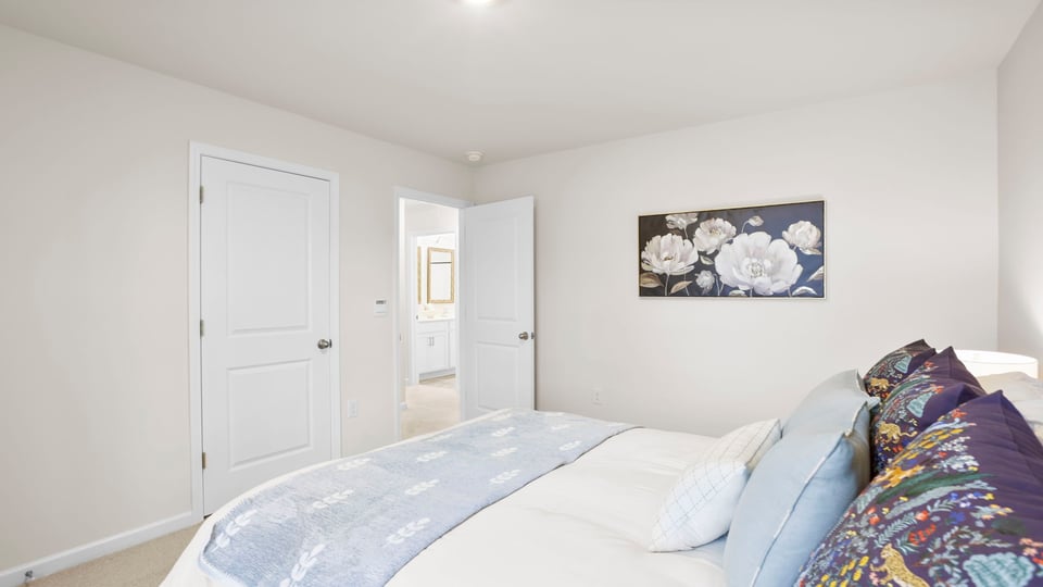 Bedroom with carpet and window.