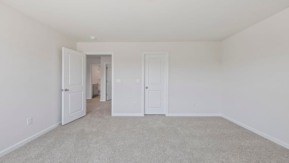 Bedroom with carpet and window.
