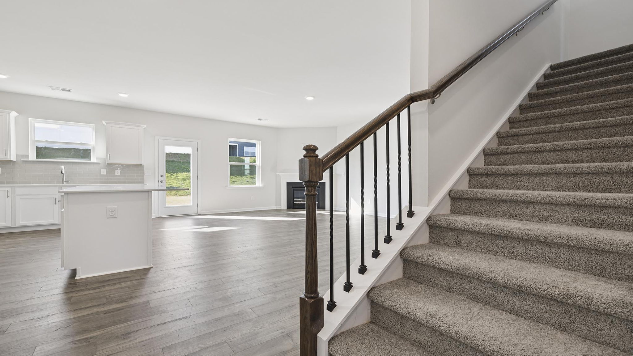 Stairs to second level with carpet.