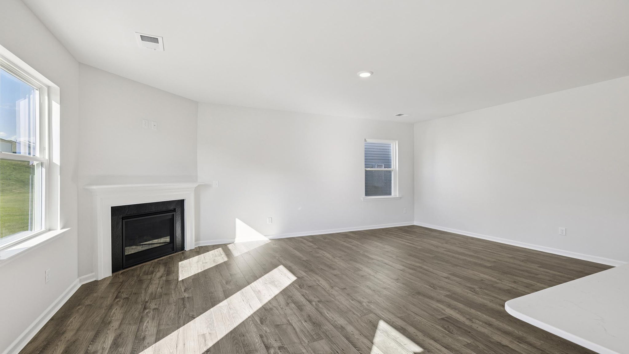 Living room with fireplace and windows.