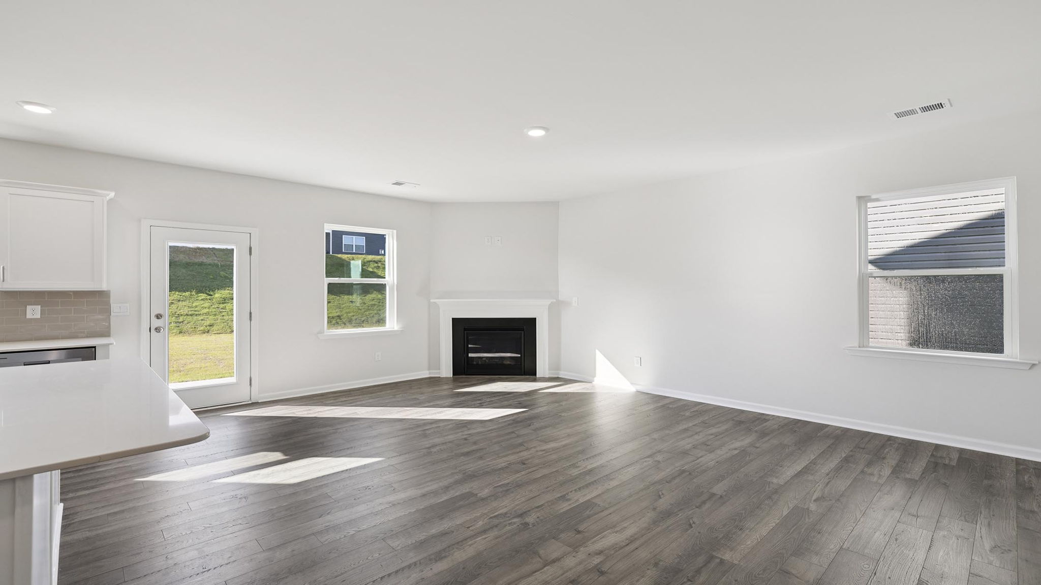 Living room with fireplace and windows.