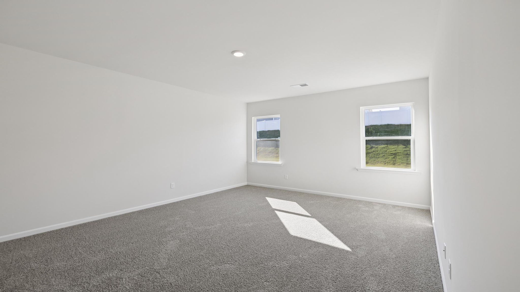 Primary bedroom with carpet.
