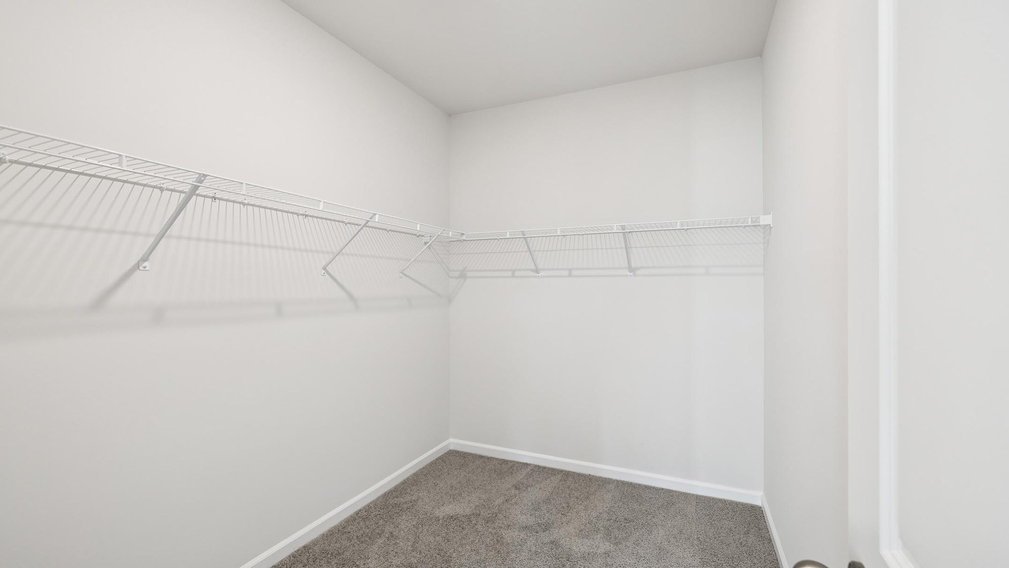 Primary closet with shelf.