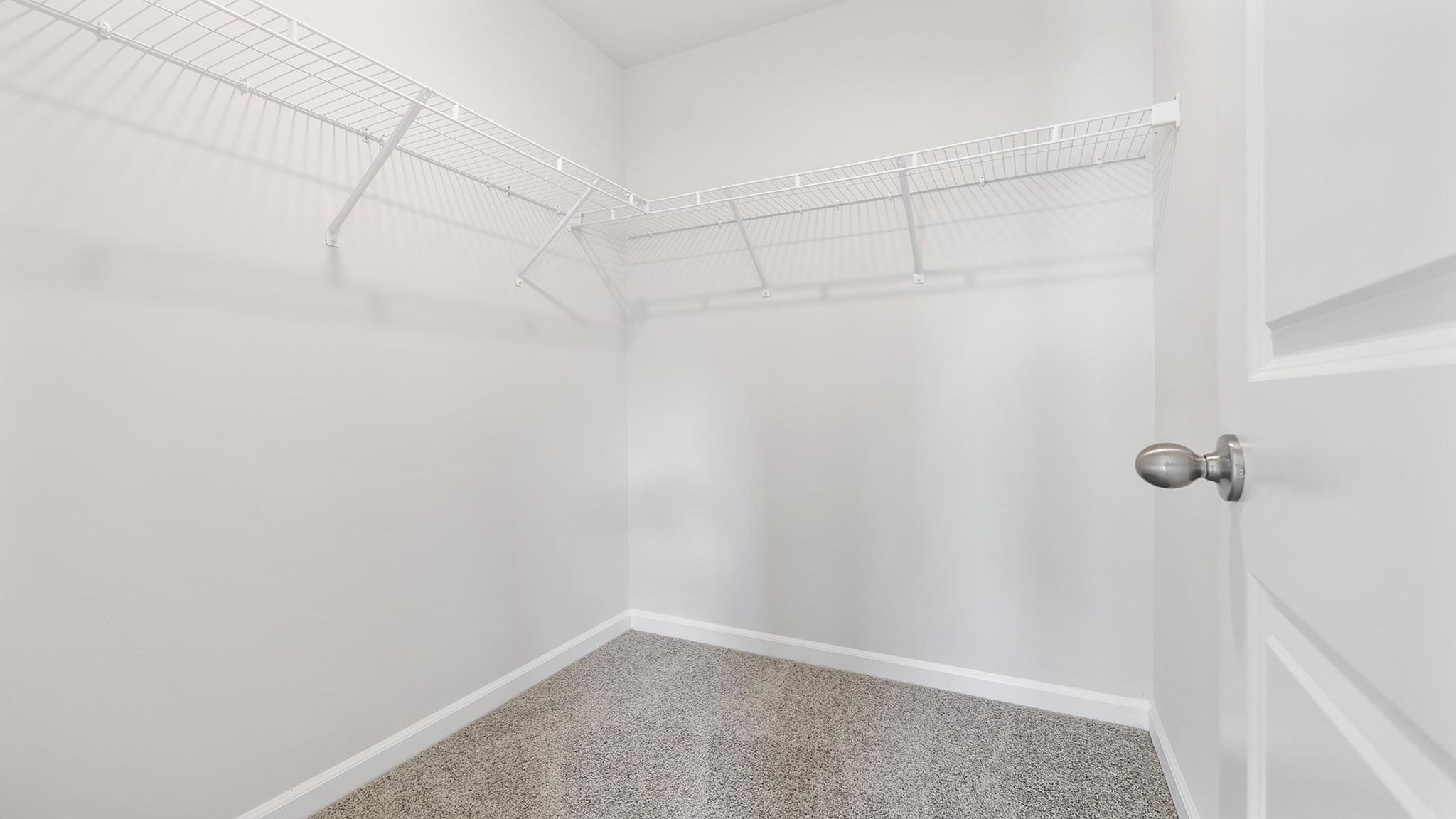 Primary closet with shelf.