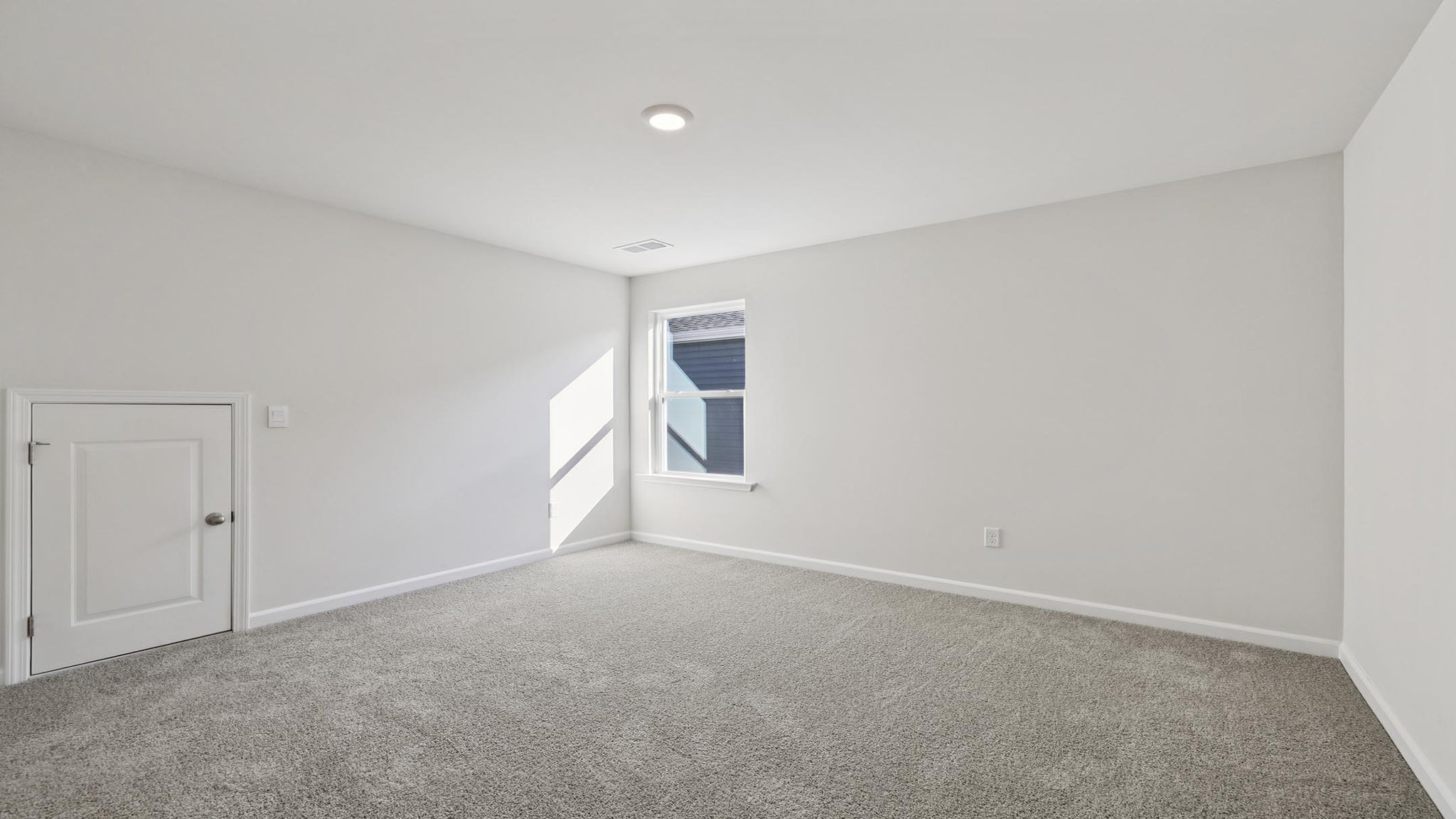 Bedroom with carpet and windows.