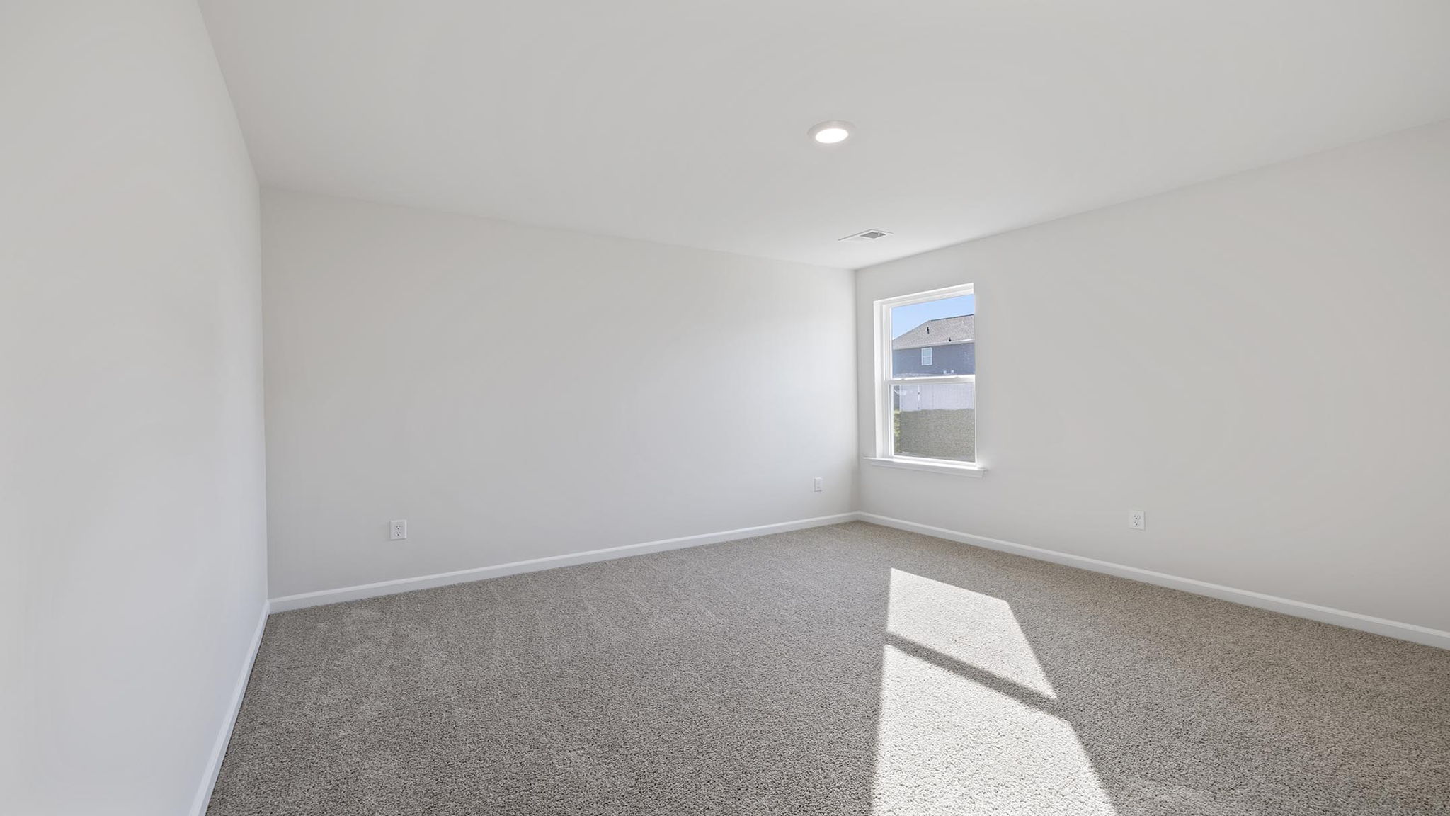 Bedroom with carpet and windows.