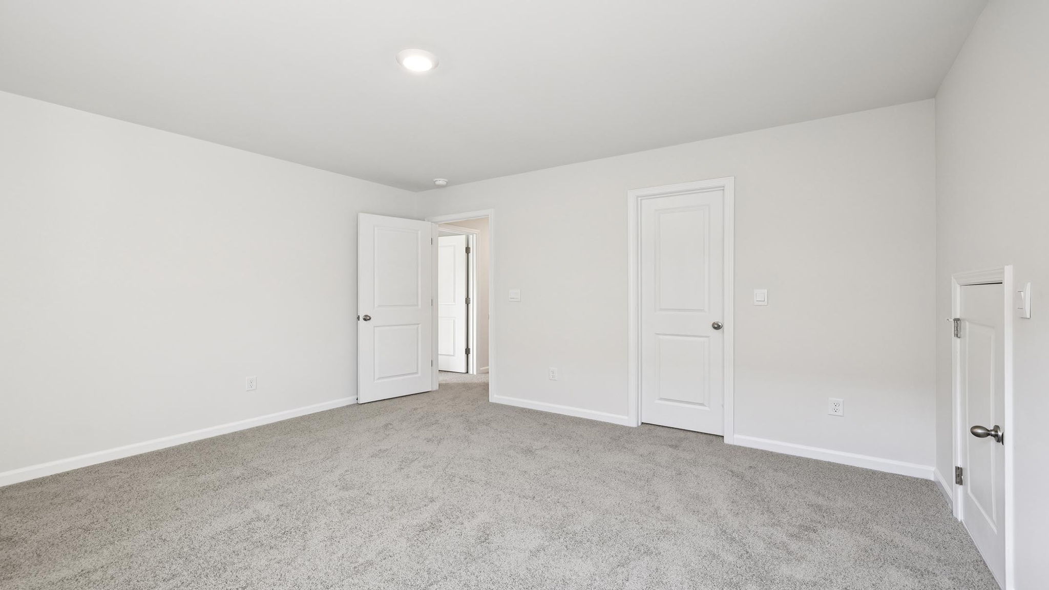 Bedroom with carpet and windows.
