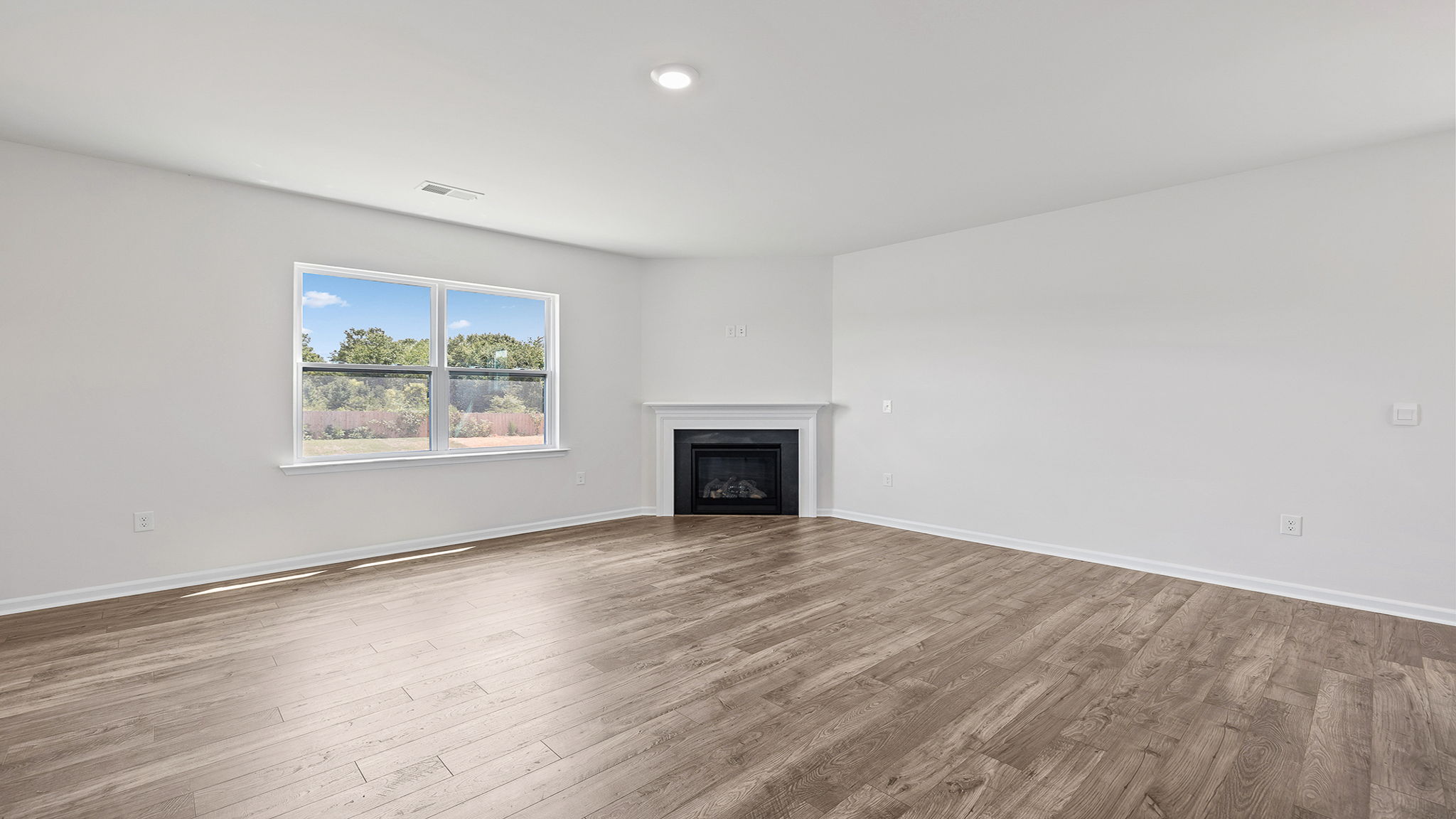 Living room with window and fireplace.