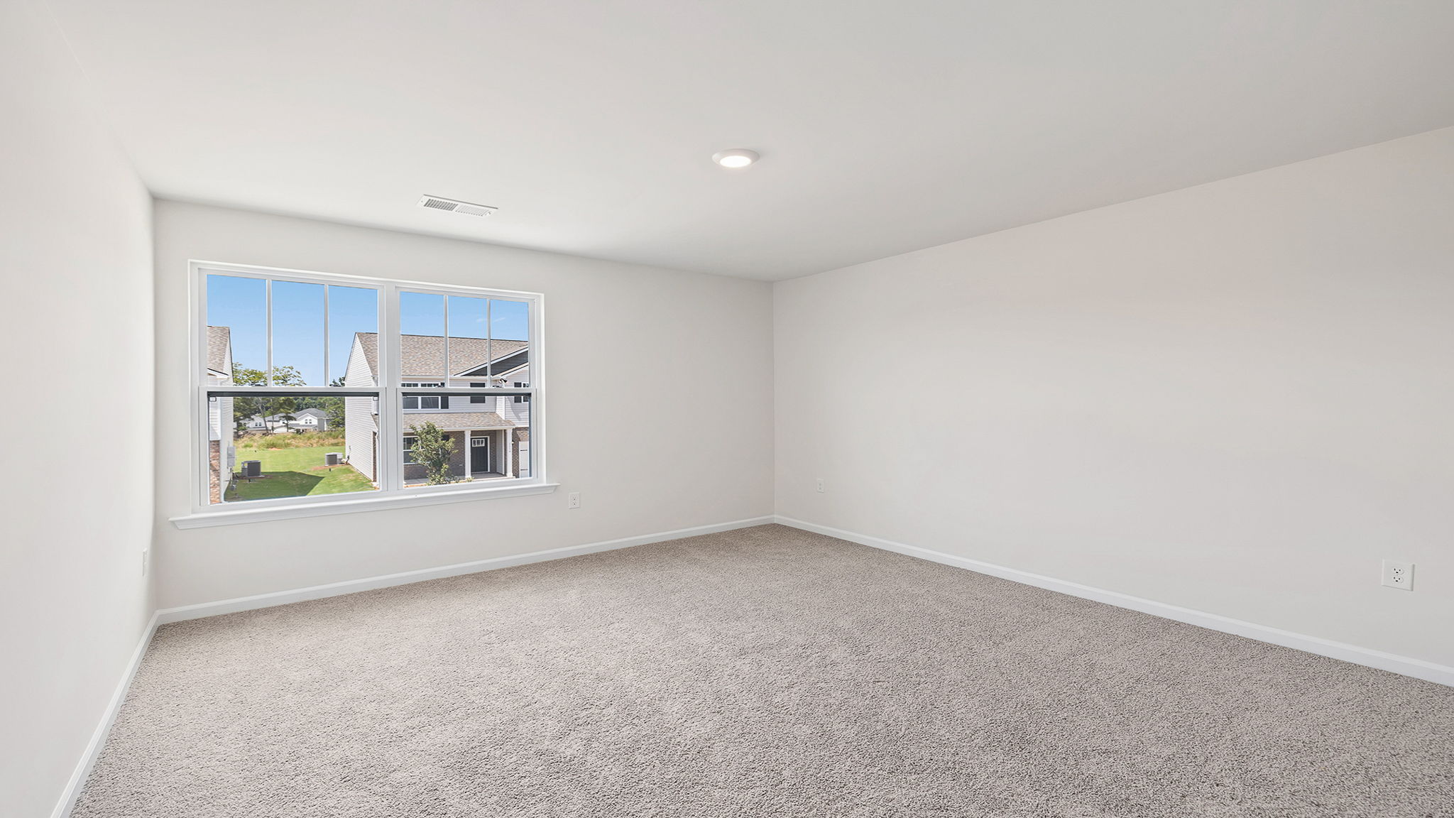 Bedroom with carpet and windows,