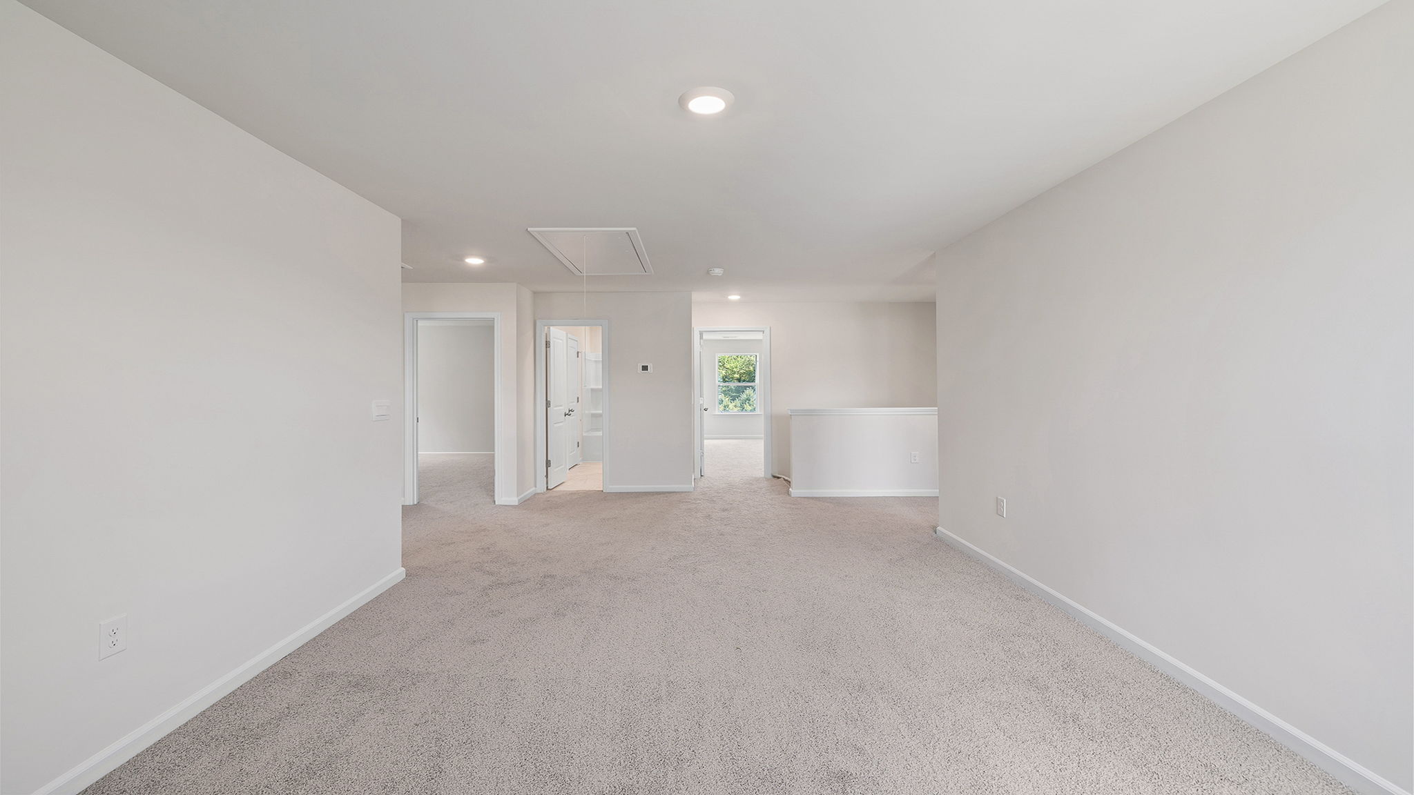 Loft with carpet and windows.