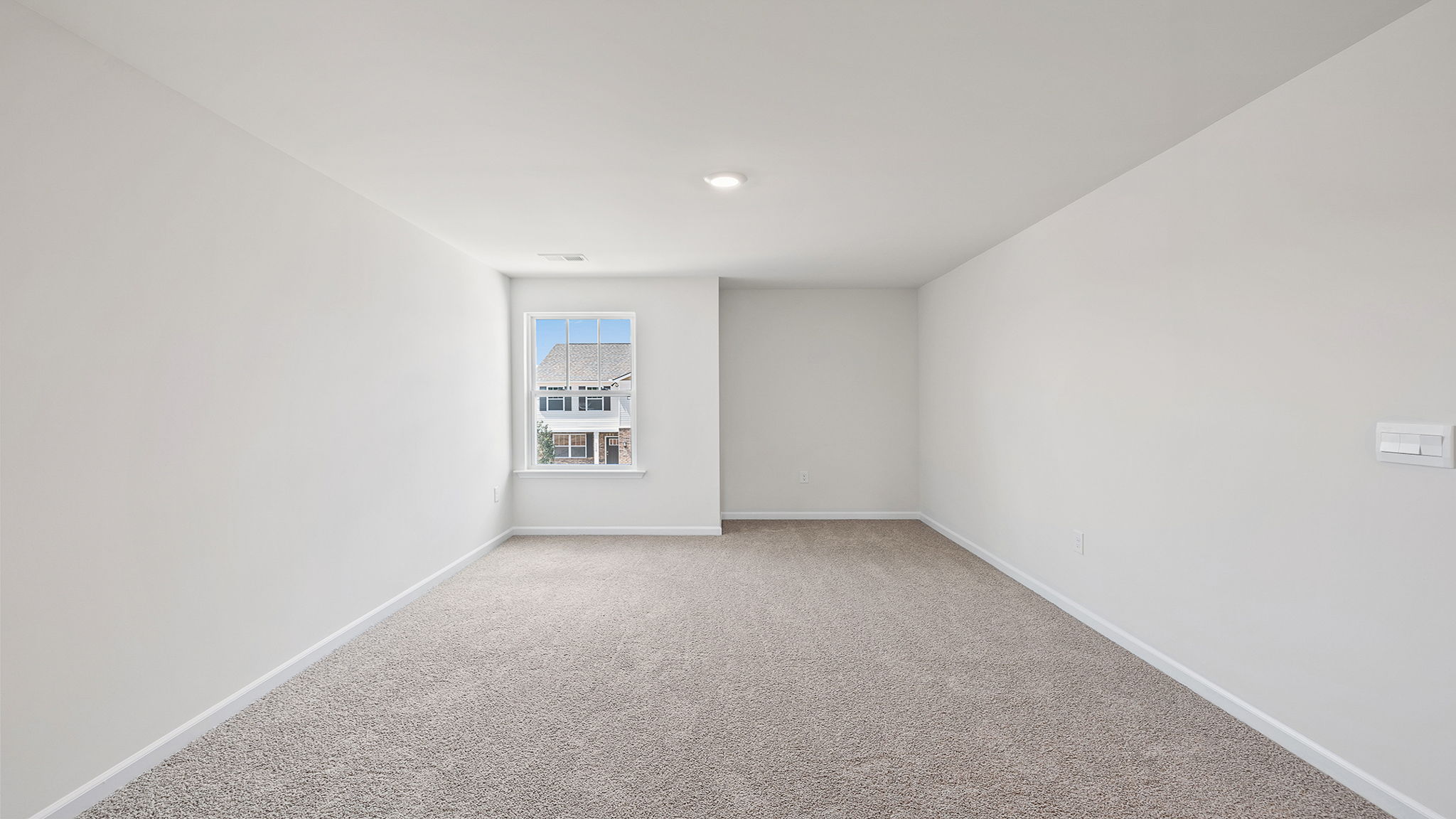 Loft with carpet and windows.