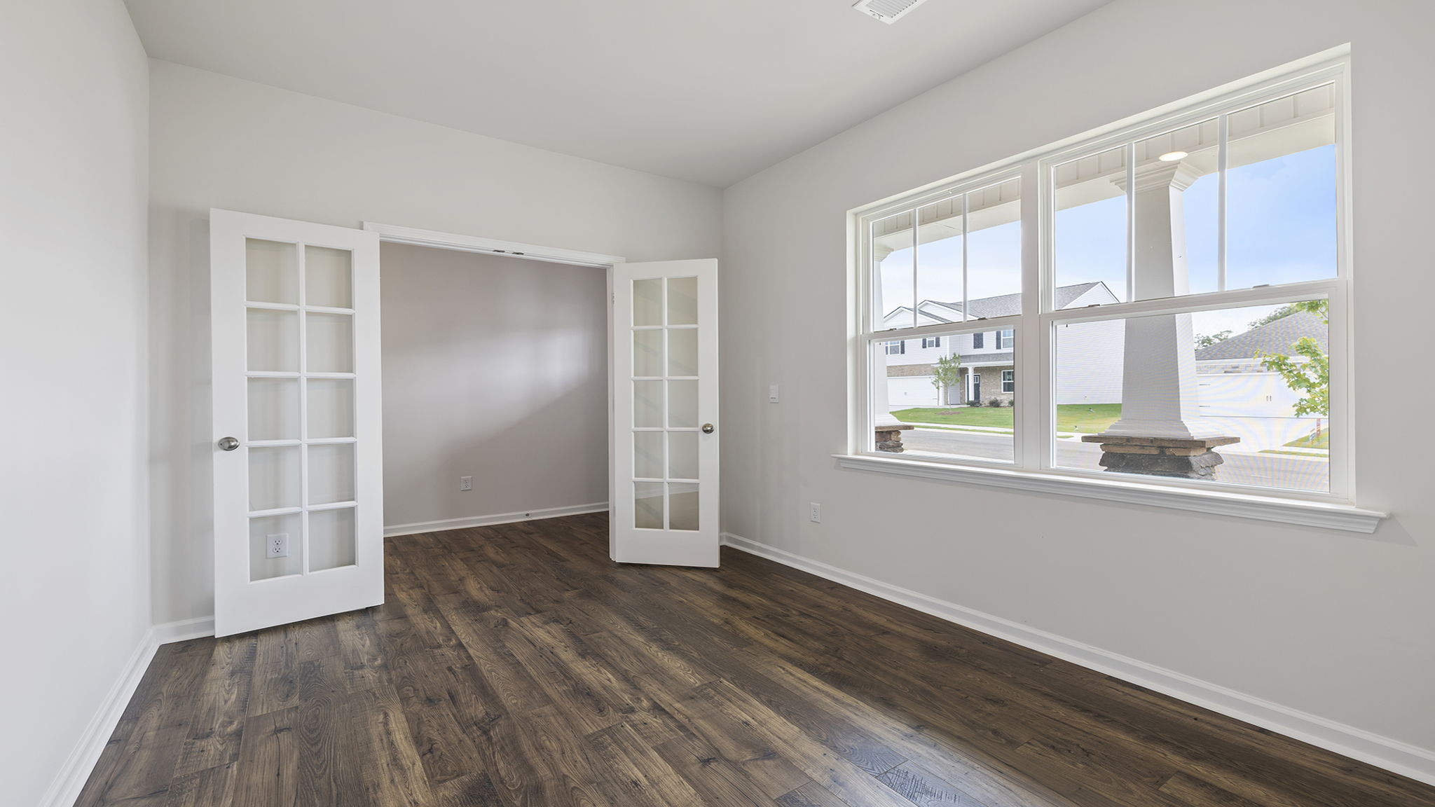 Study accented by large windows and French doors.