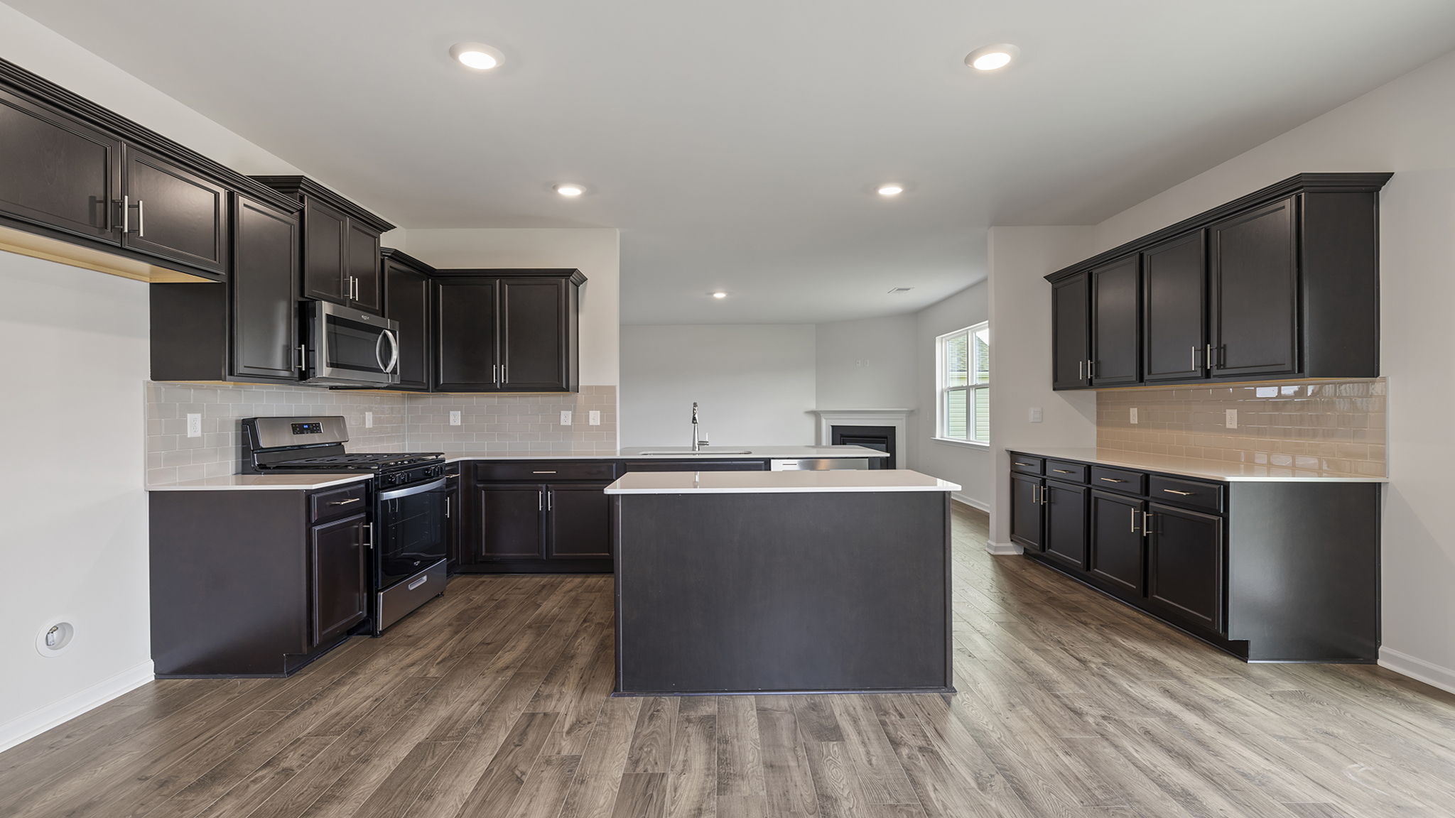 Open kitchen with island and recessed lighting.