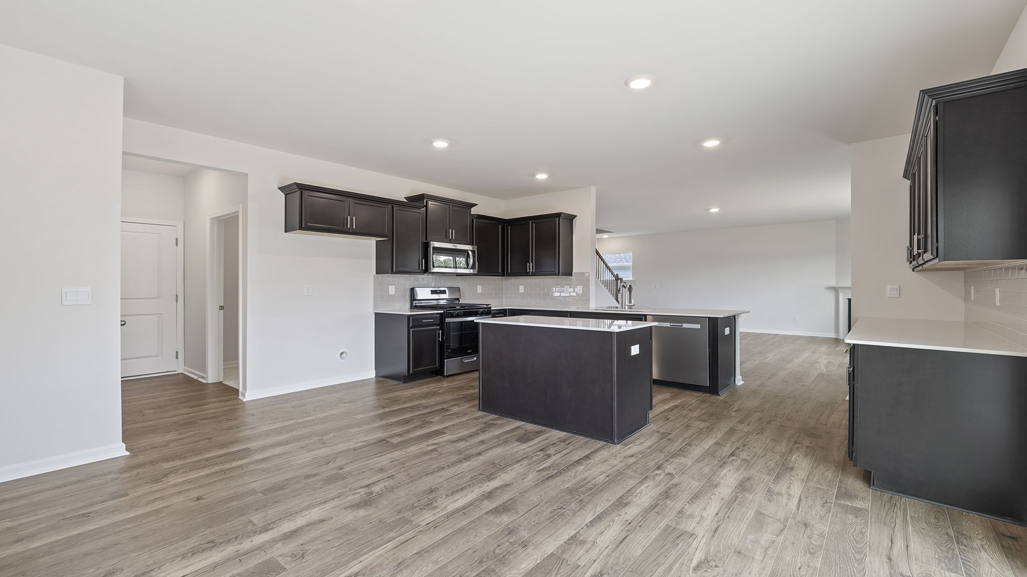 View of large kitchen with quartz countertops.