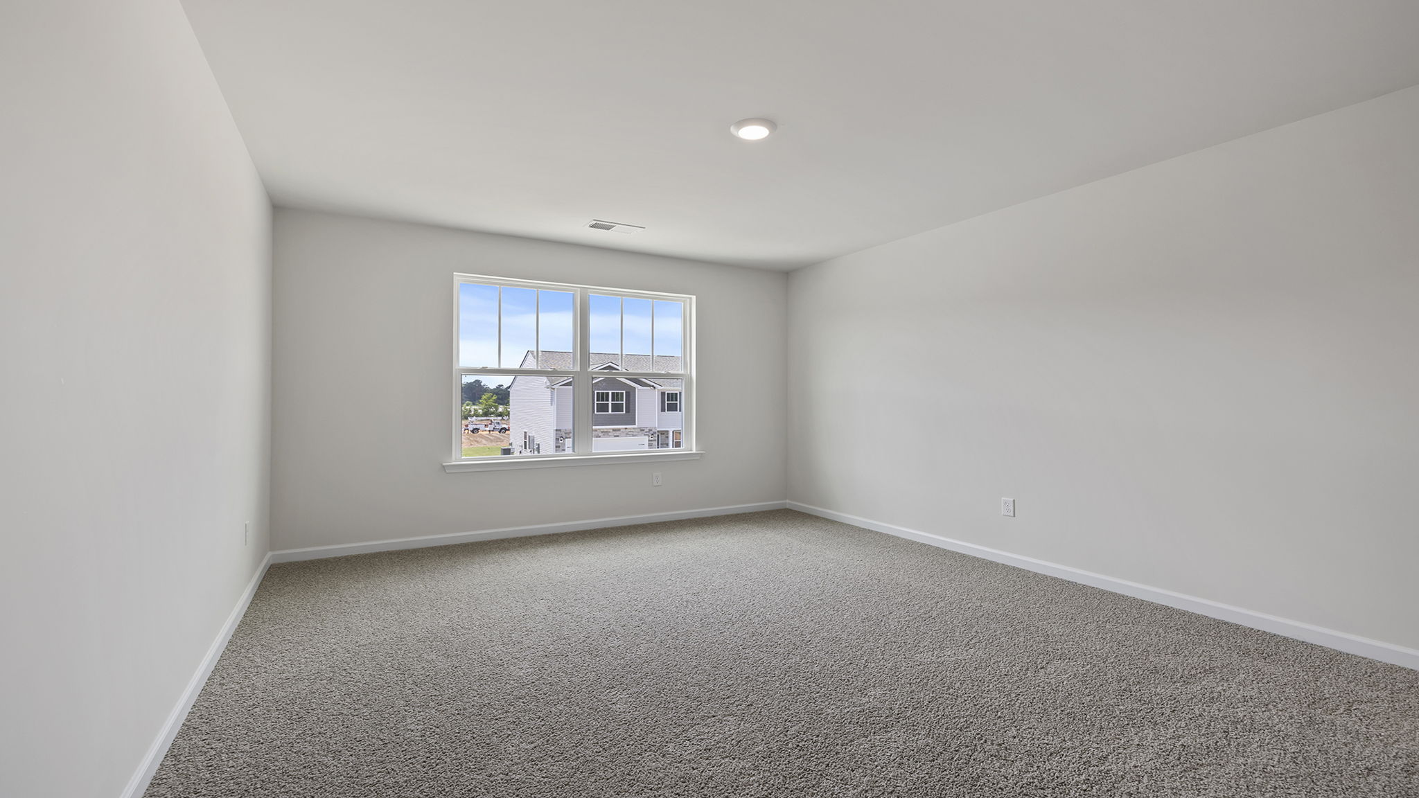 Bedroom with window and carpet.