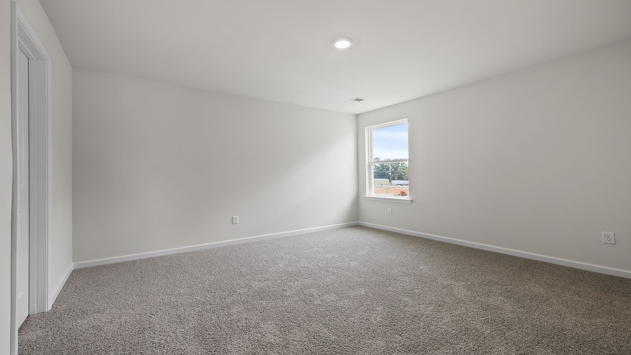 Bedroom with window and carpet.