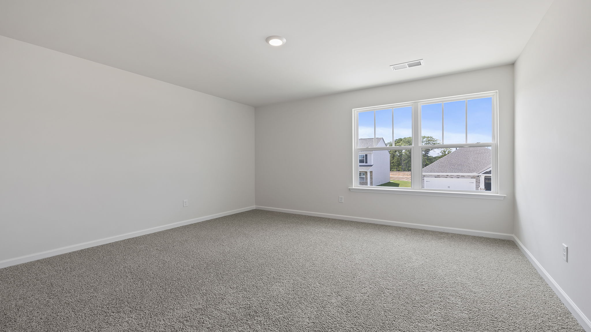 Bedroom with window and carpet.