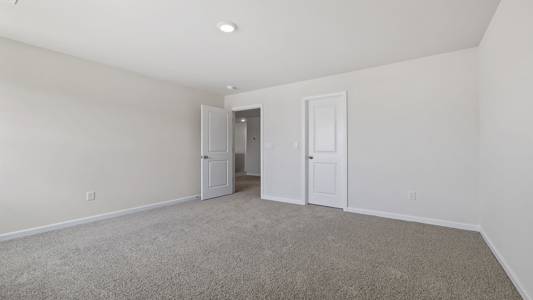 Bedroom with window and carpet.