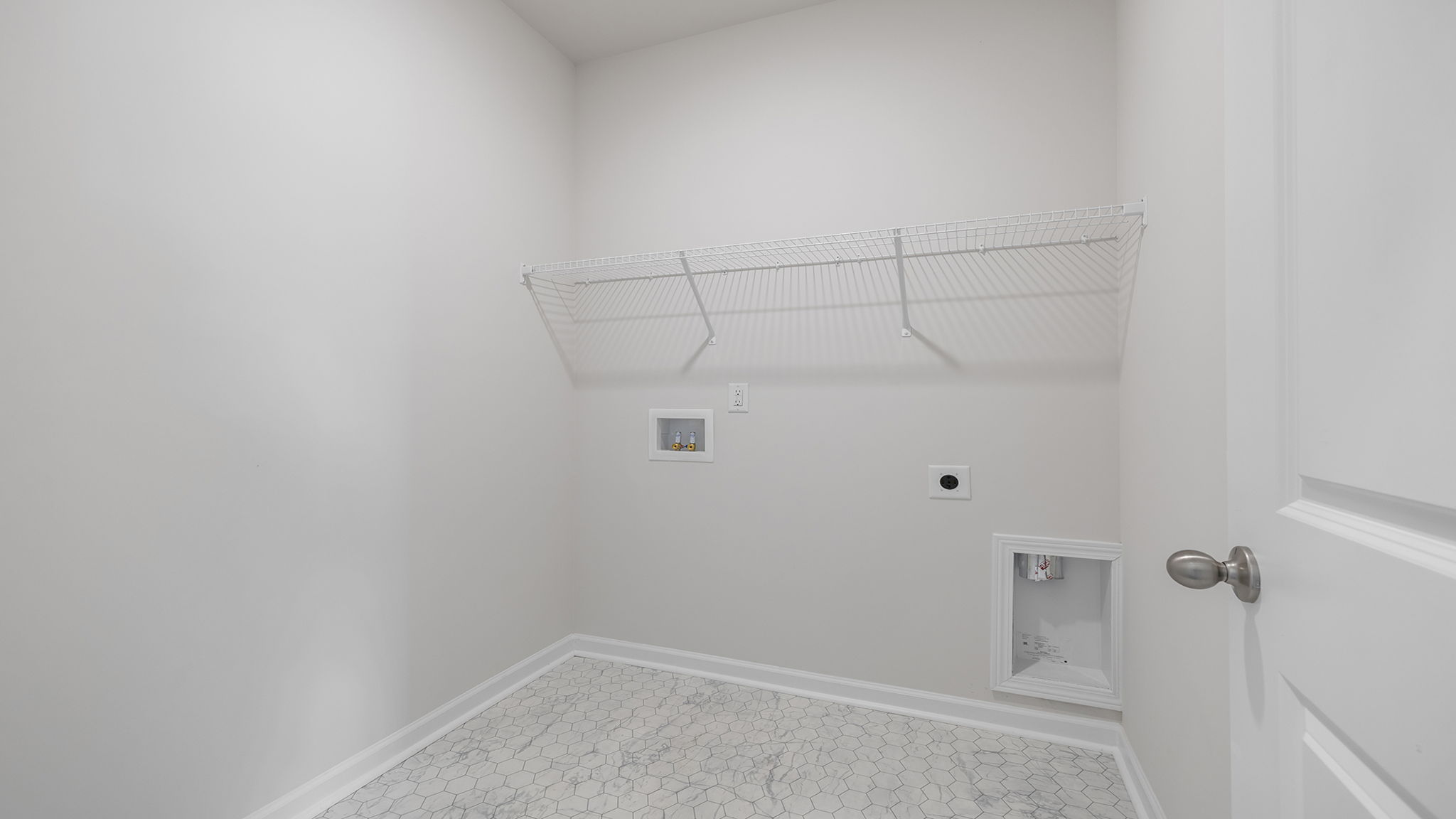 Walk-in laundry room with shelving.