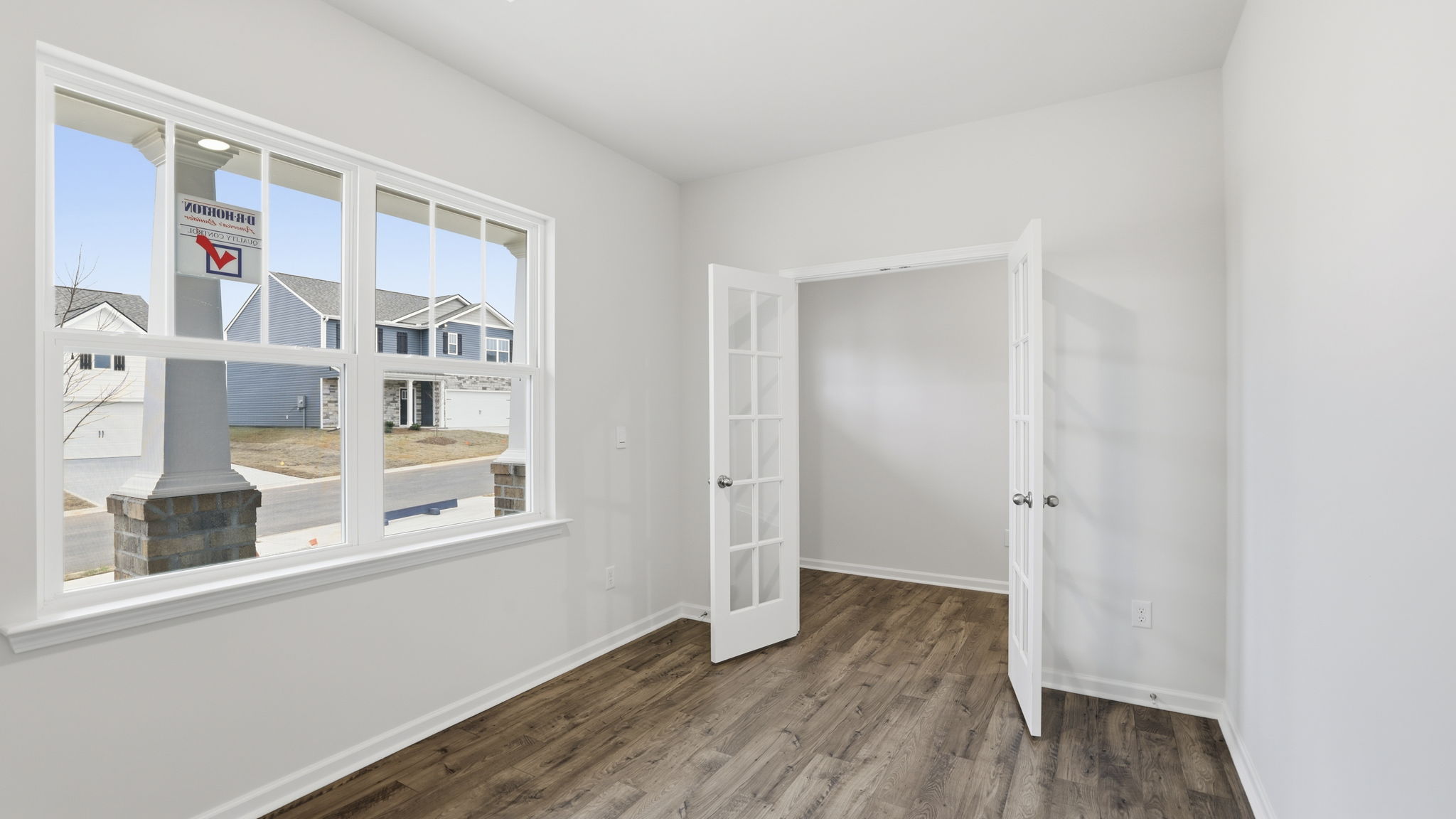 Study at front of home with large window.