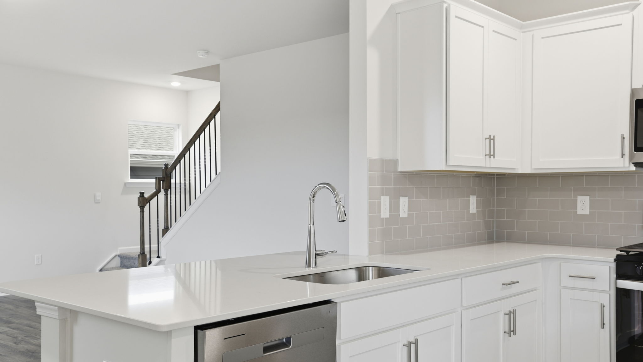 Kitchen island with sink and dishwasher.