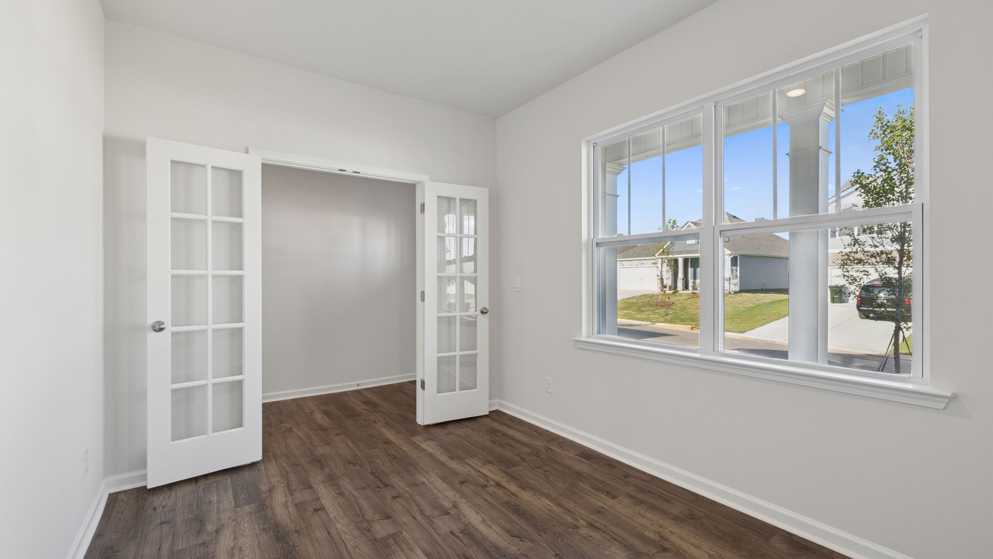 Study accented by large windows and French doors.