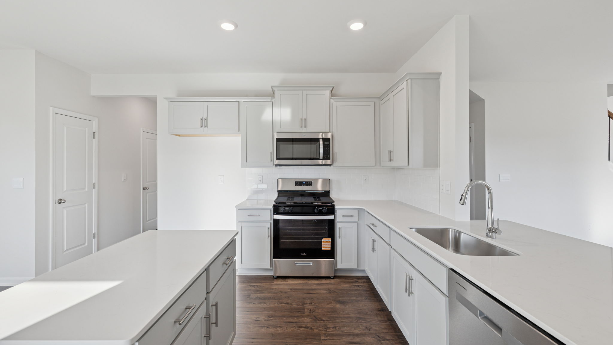 Island and kitchen have quartz countertops.