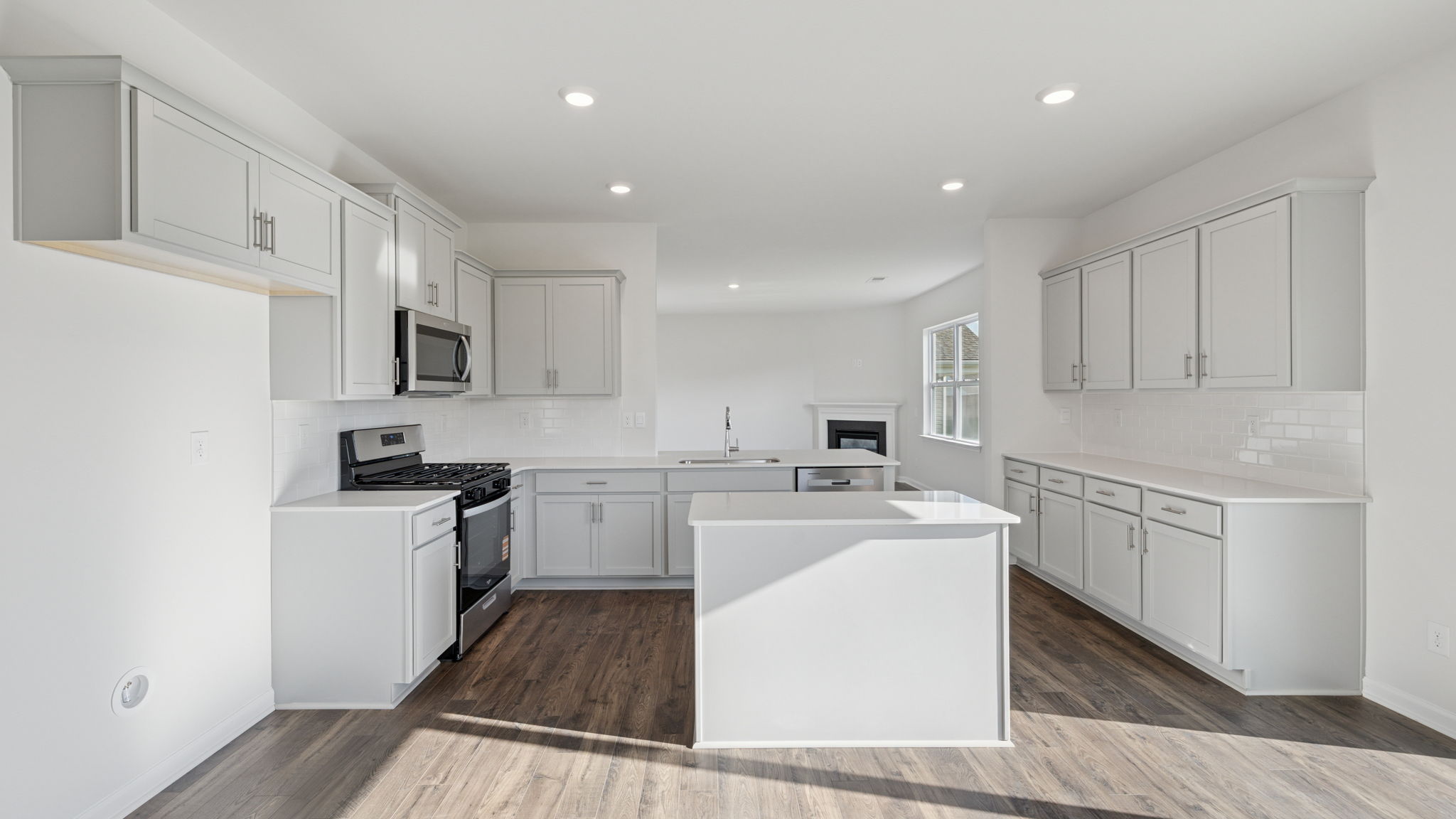 Open kitchen with island and recessed lighting.