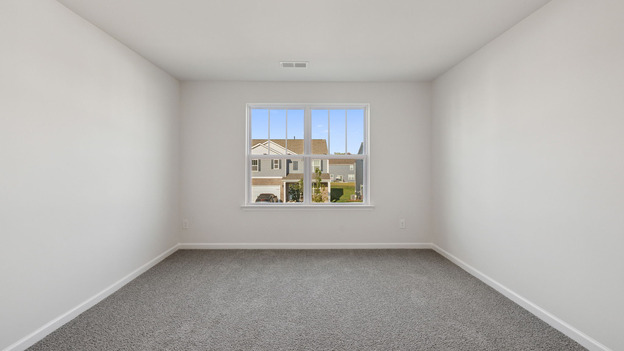 Bedroom with window and carpet.