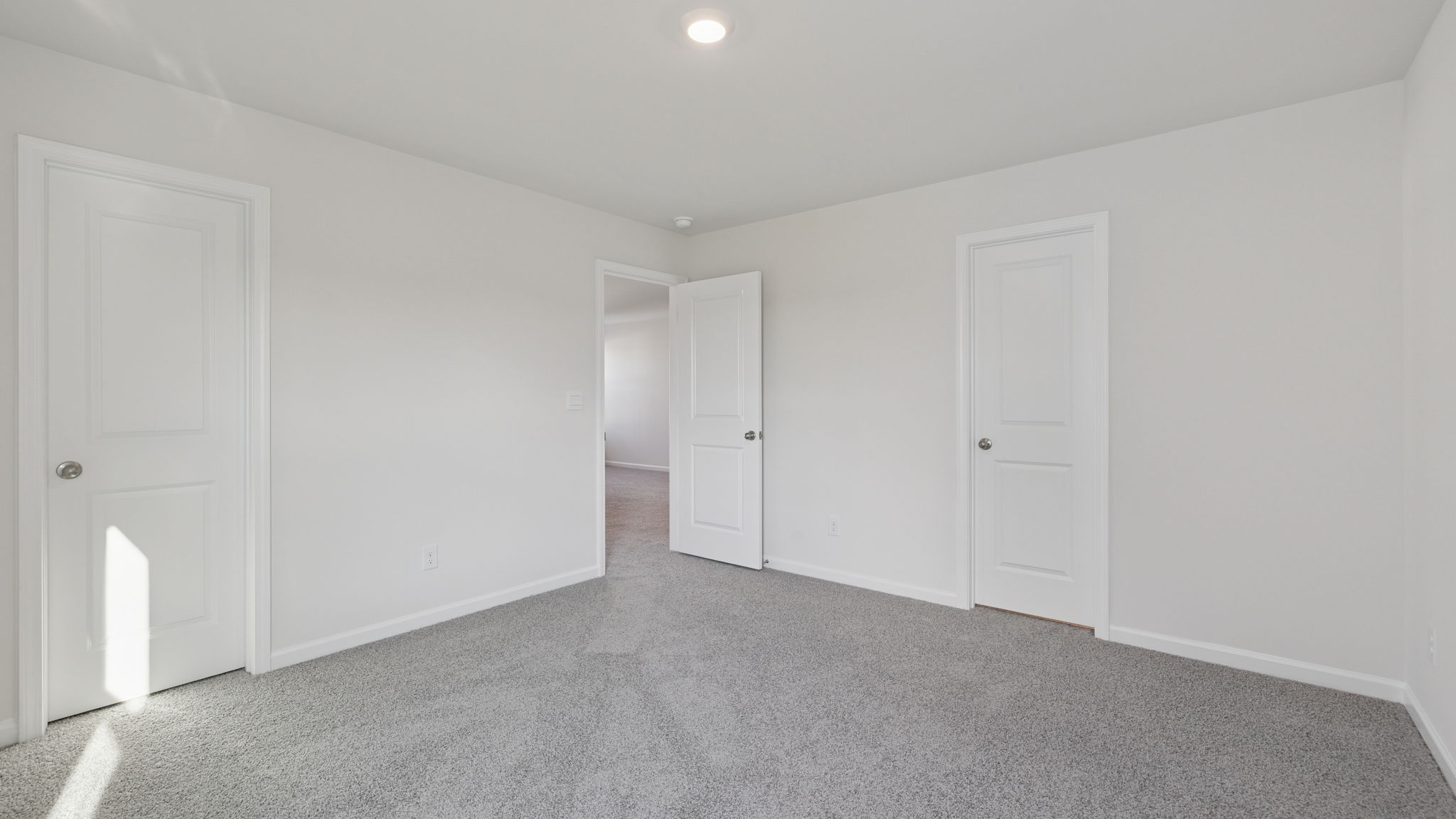 Bedroom with window and carpet.