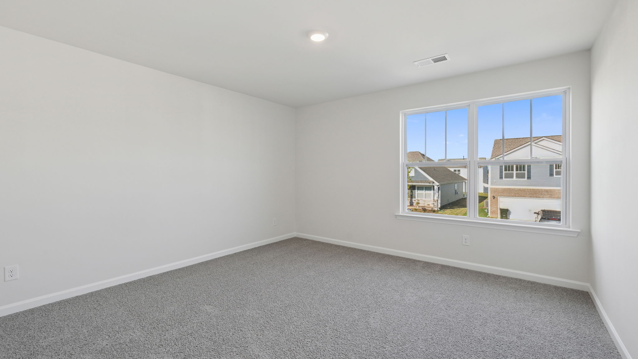 Bedroom with window and carpet.
