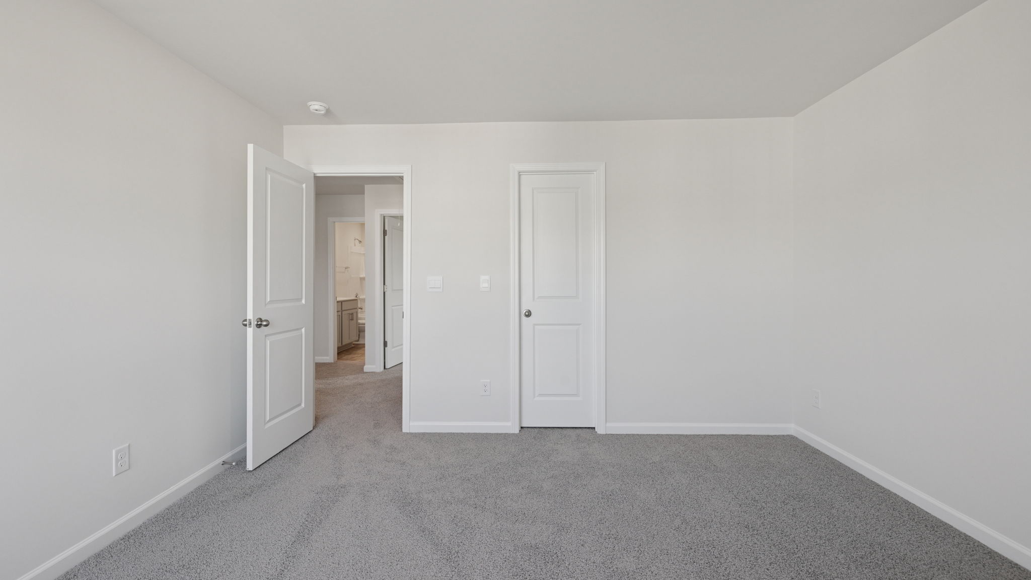 Bedroom with window and carpet.