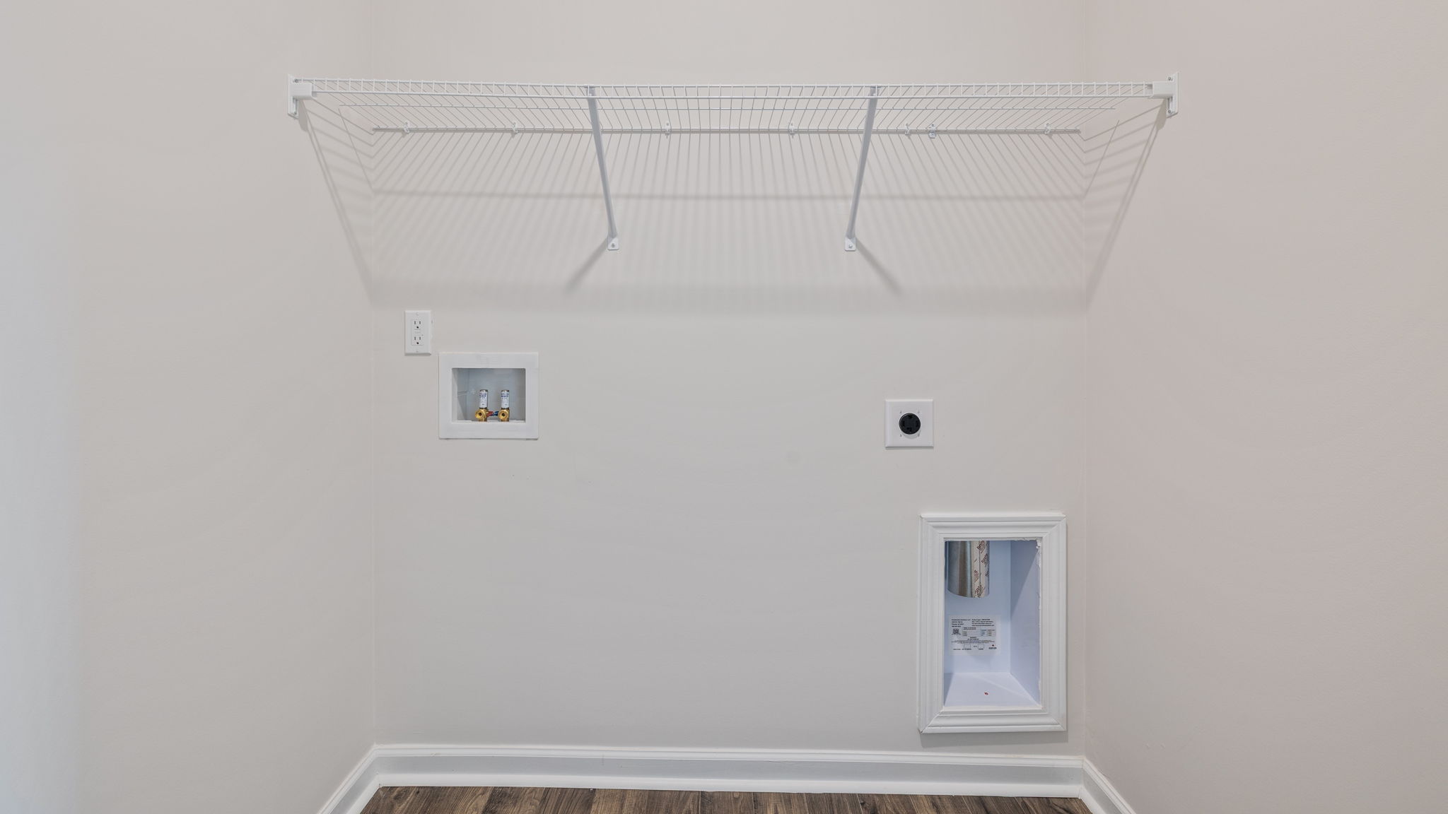 Walk-in laundry room with shelving.