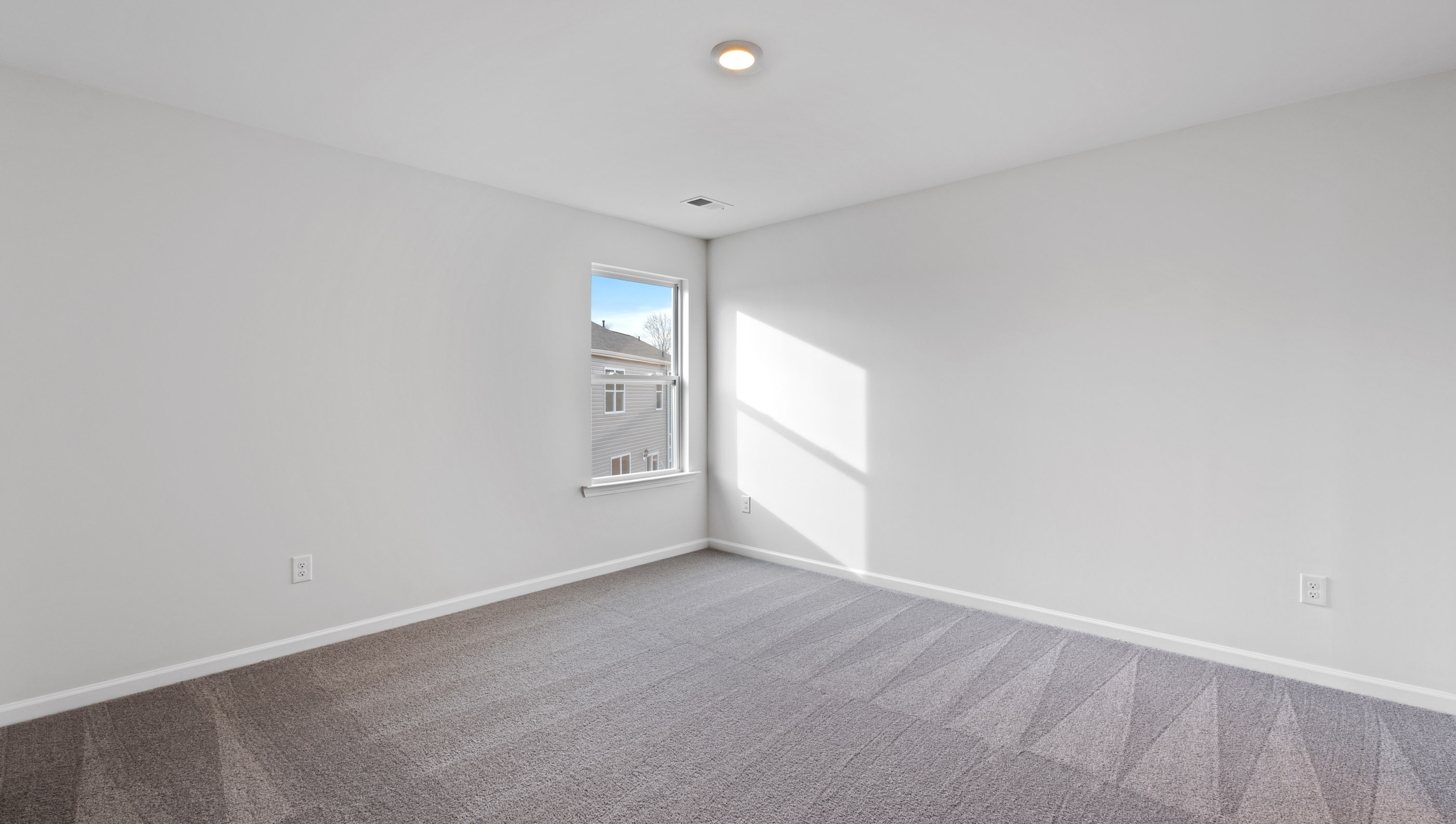Bedroom with window and carpet.