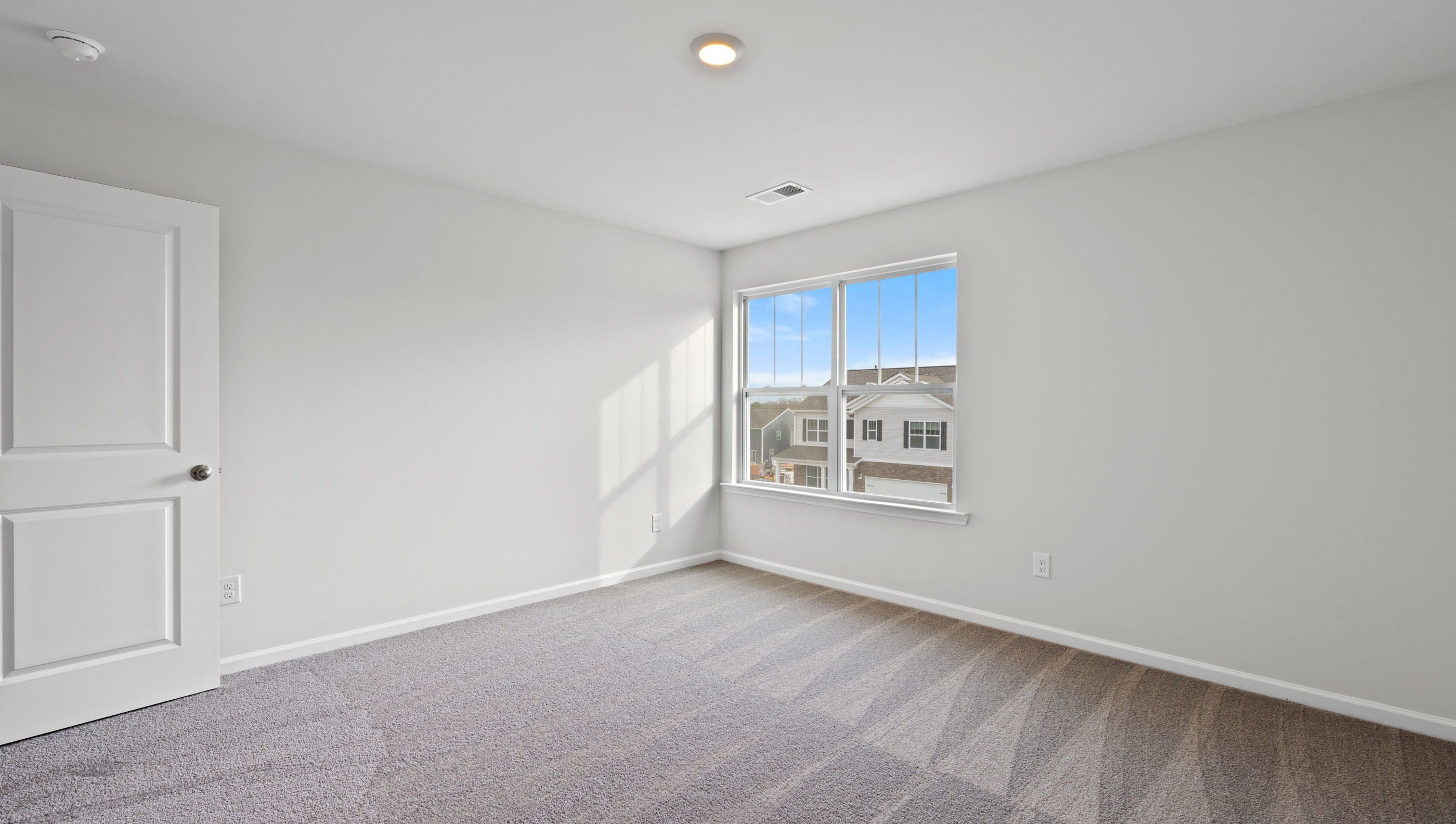 Bedroom with window and carpet.