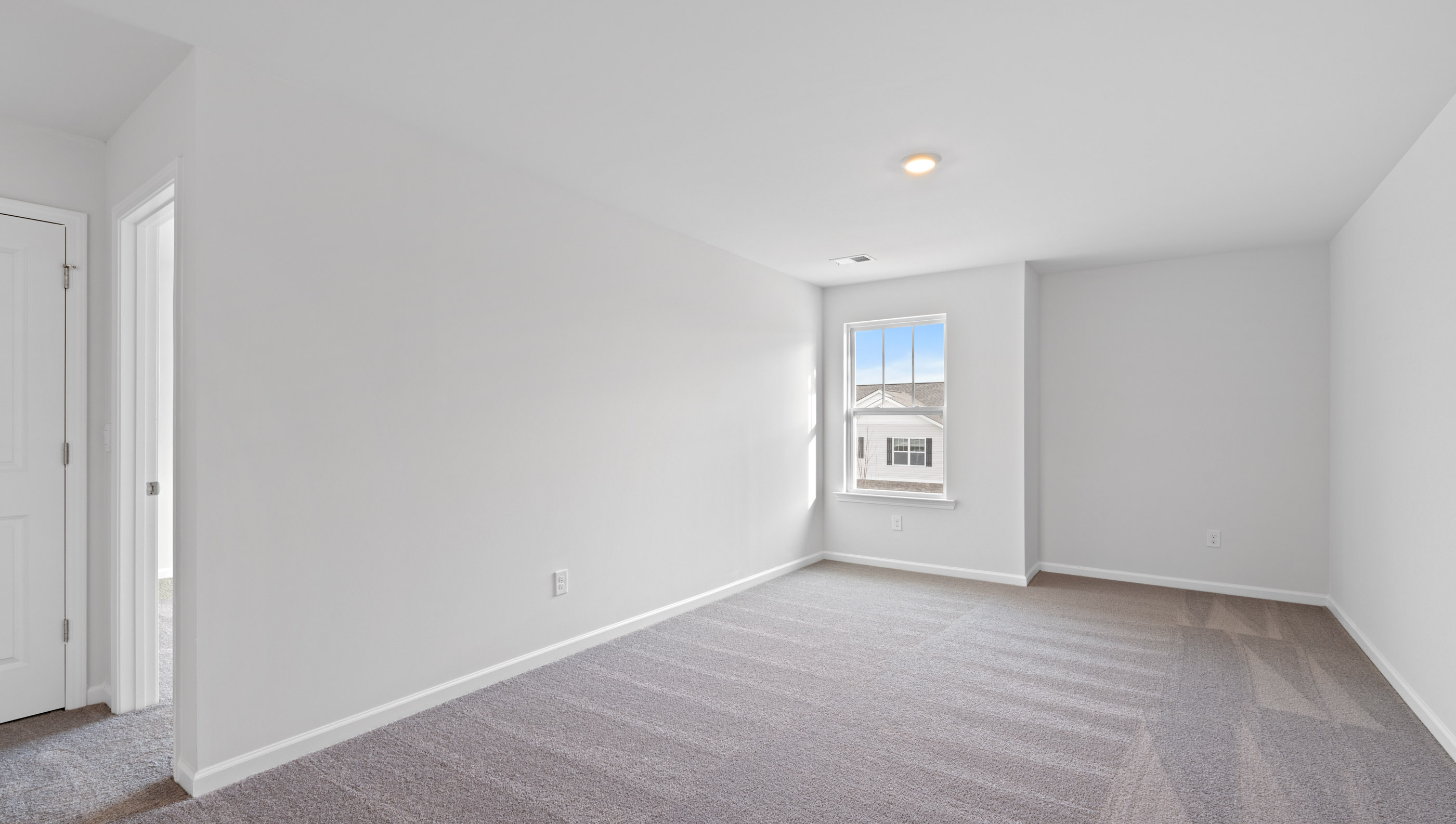 Loft with window and carpet.