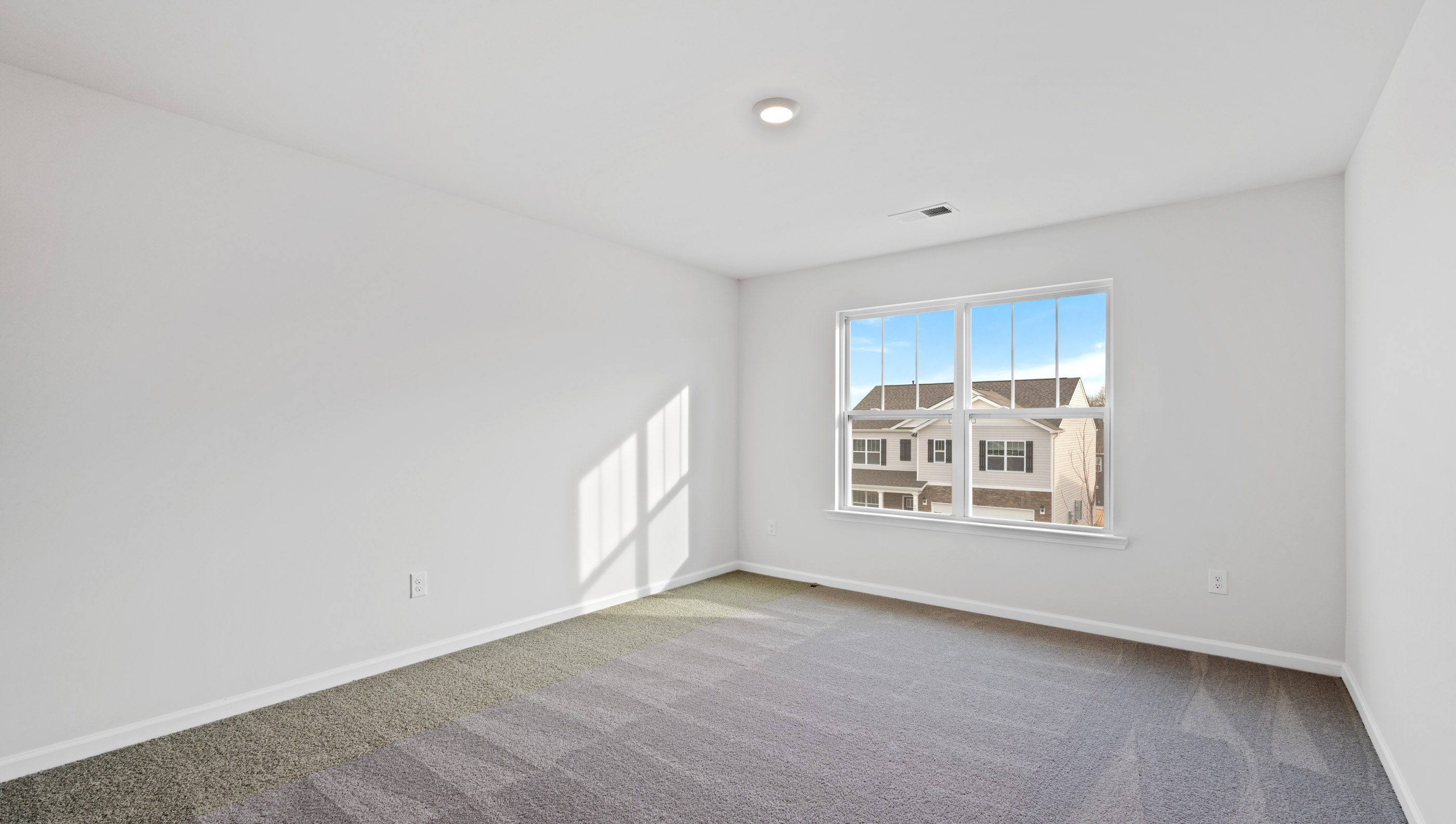 Bedroom with window and carpet.