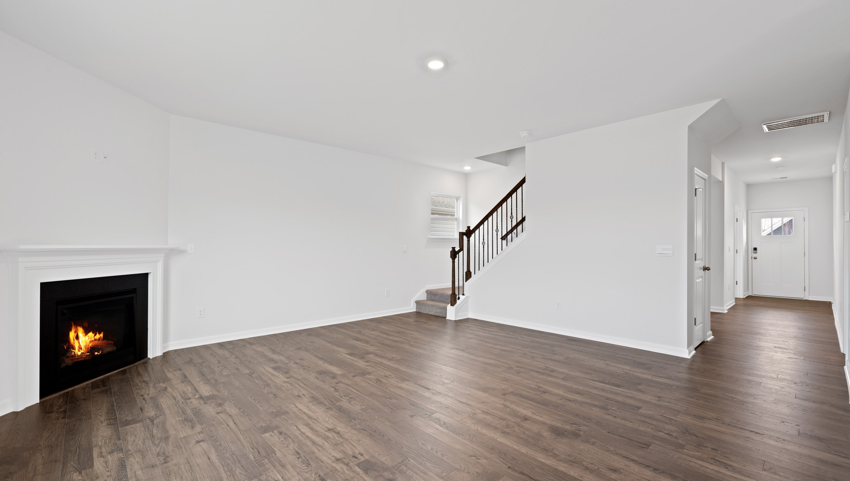 View of family room, stairwell and front entrance.