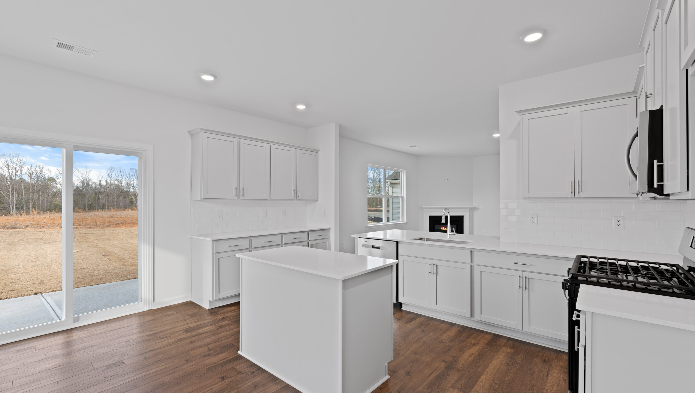 Kitchen with white cabinets and island.