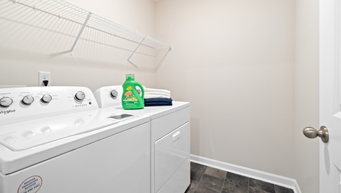 Laundry room with hanging storage racks.