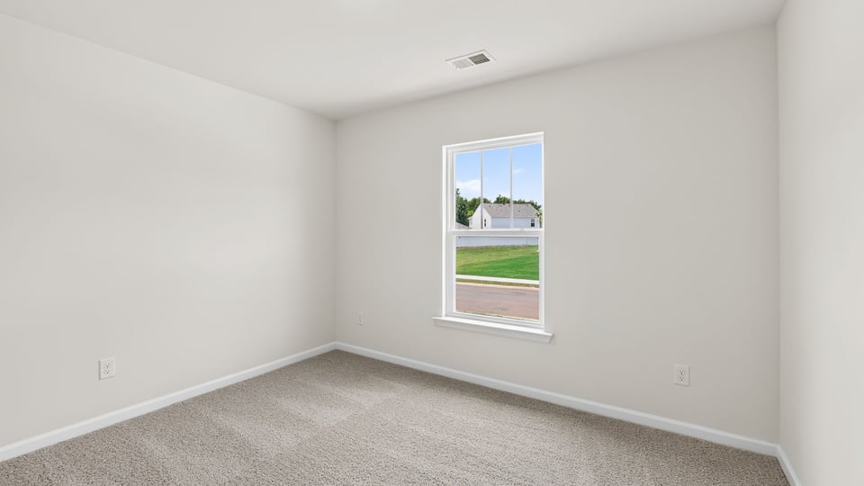 Bedroom with window and carpet.