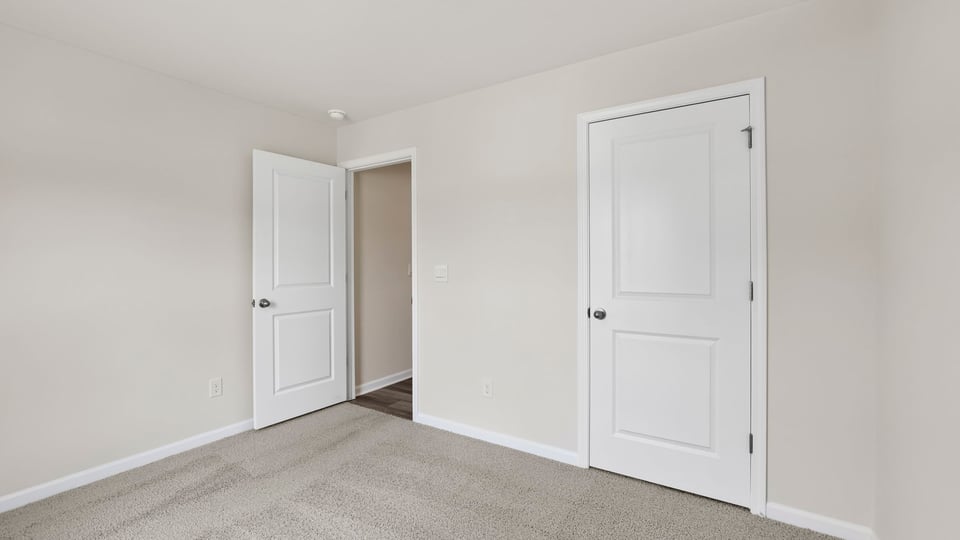 Bedroom with window and carpet.