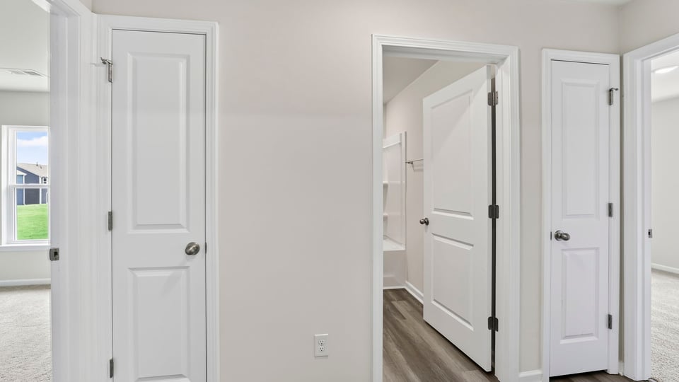 View of hallway between two bedrooms.