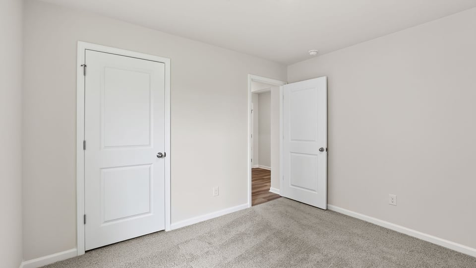 Bedroom with window and carpet.