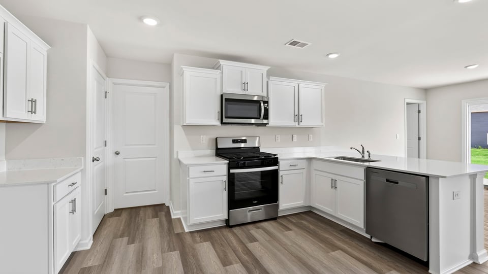 View of kitchen with quartz countertops.
